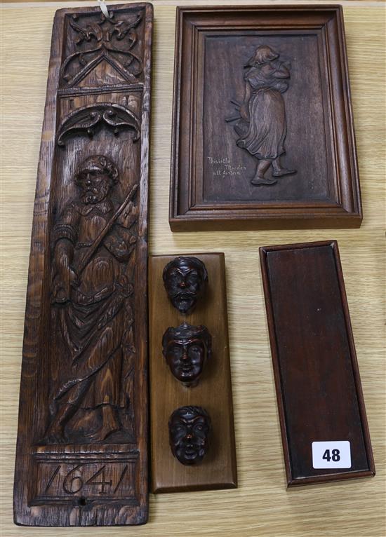 A group of carved heads, a carved panel etc (4)